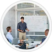 Picture of people in a meeting with a whiteboard